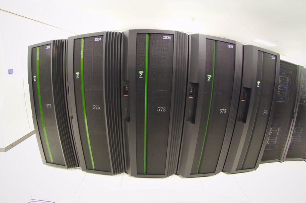 A large data centre hall filled with computing racks and cabling